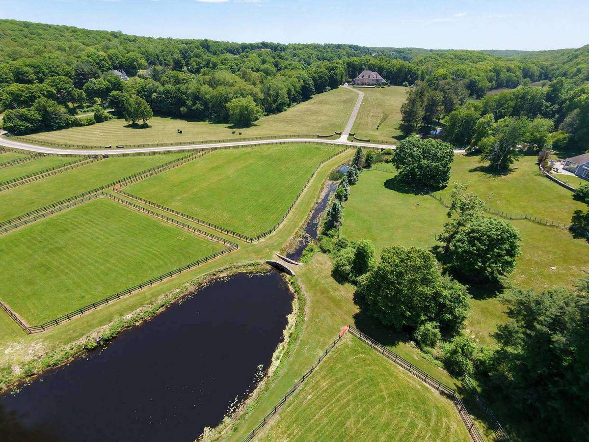 Aerial view of Red Gate Farm pastures, pond and manor