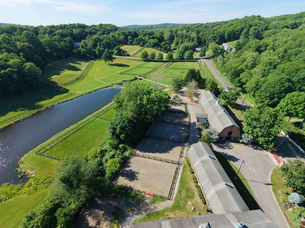 Aerial of the barns and arenas along the river