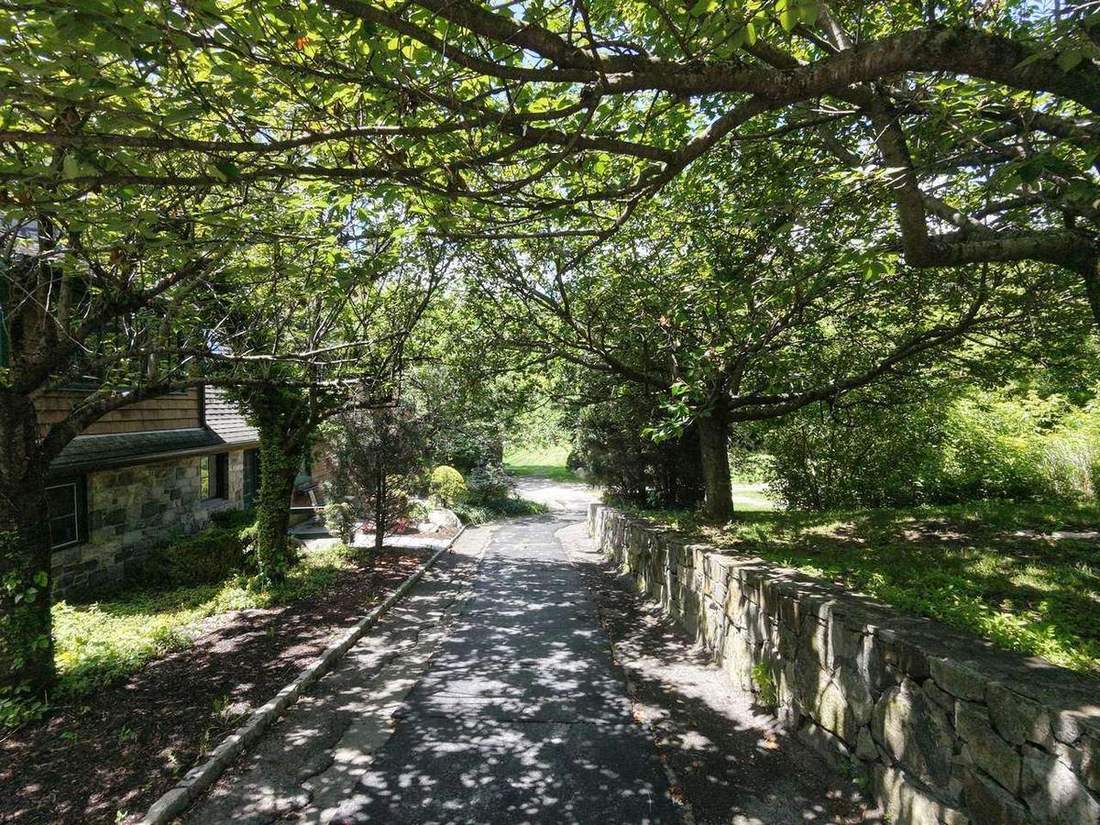 A shaded, stone-walled lane