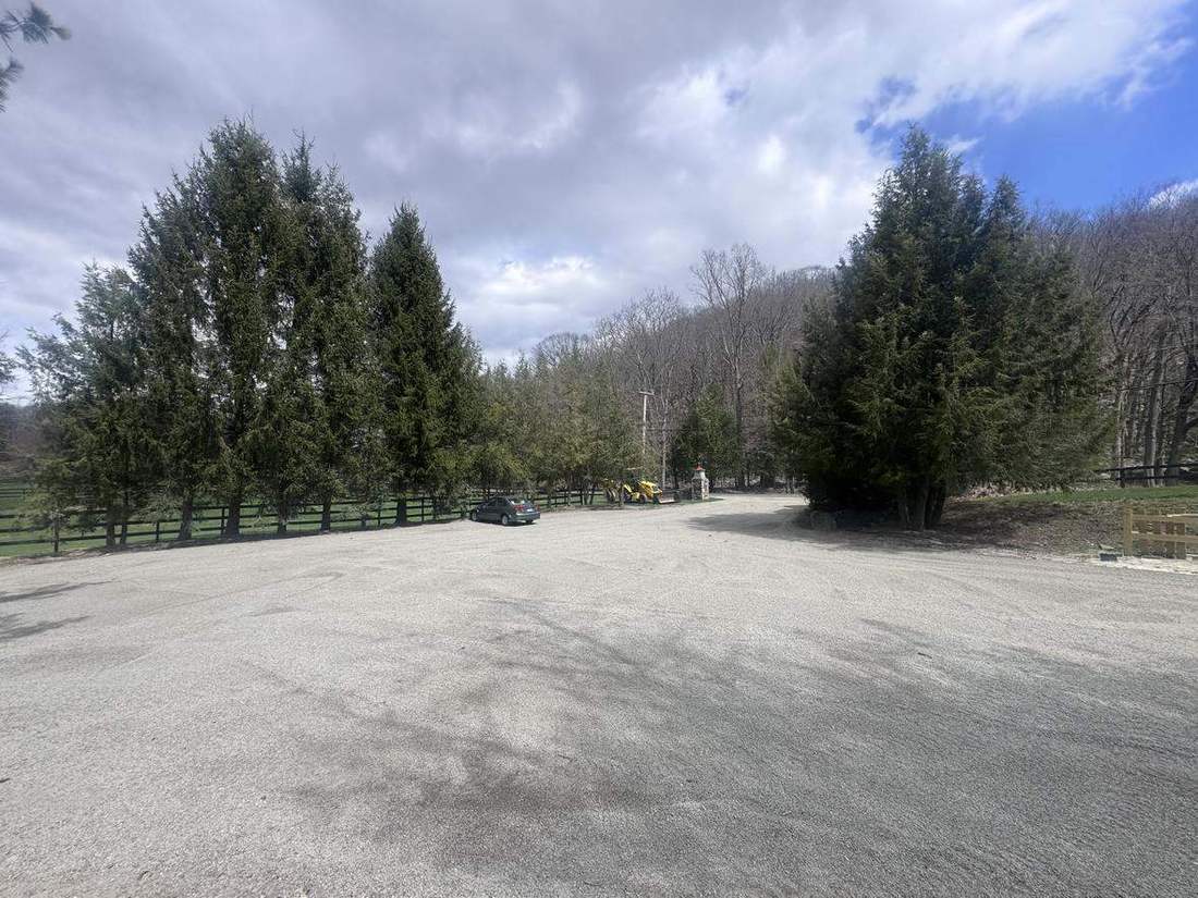 An outdoor ring framed by pines